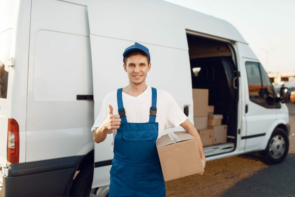 Deliveryman in uniform shows thumbs up, delivery